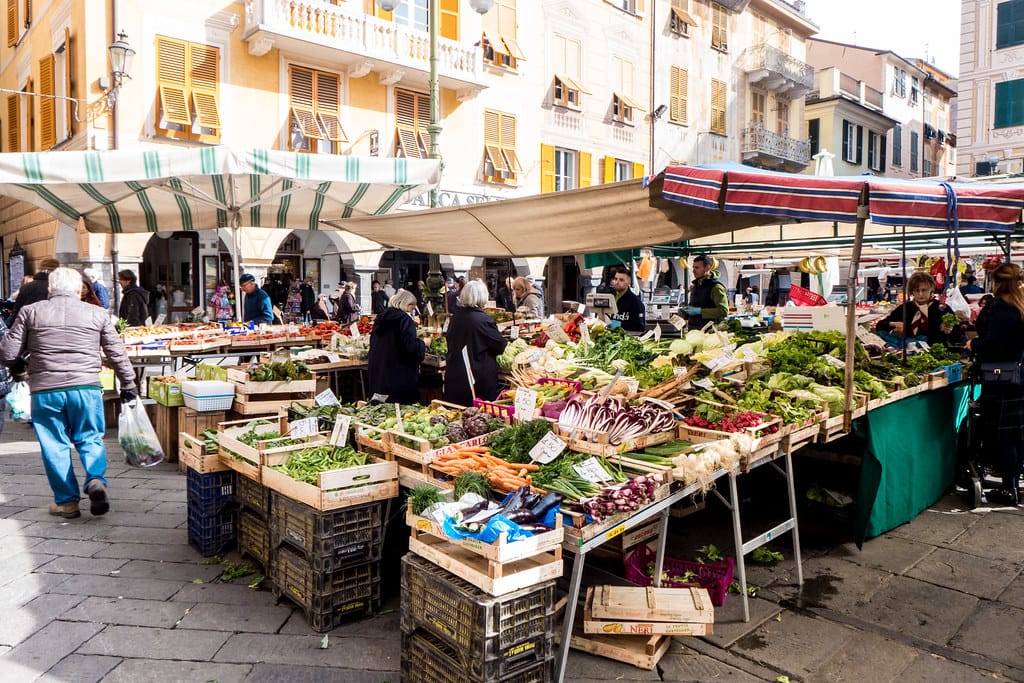 un mercato con venditori di frutta e verdura